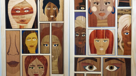 Chelsea Van Vorhis' piece, "WE ARE THE SILENT SURVIVORS ROOM SCREEN", a room divider decorated with works of art crafted from various wood veneers to make up many women's faces.