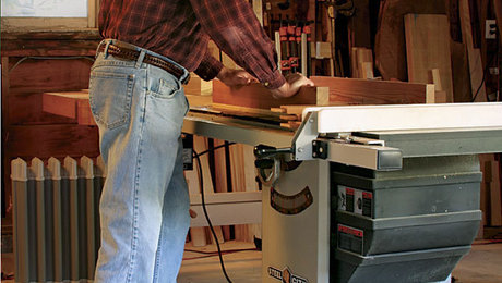 A man stands on an anti-fatigue mat in the wood shop