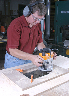 Use a template to rout the opening for the router mounting plate
